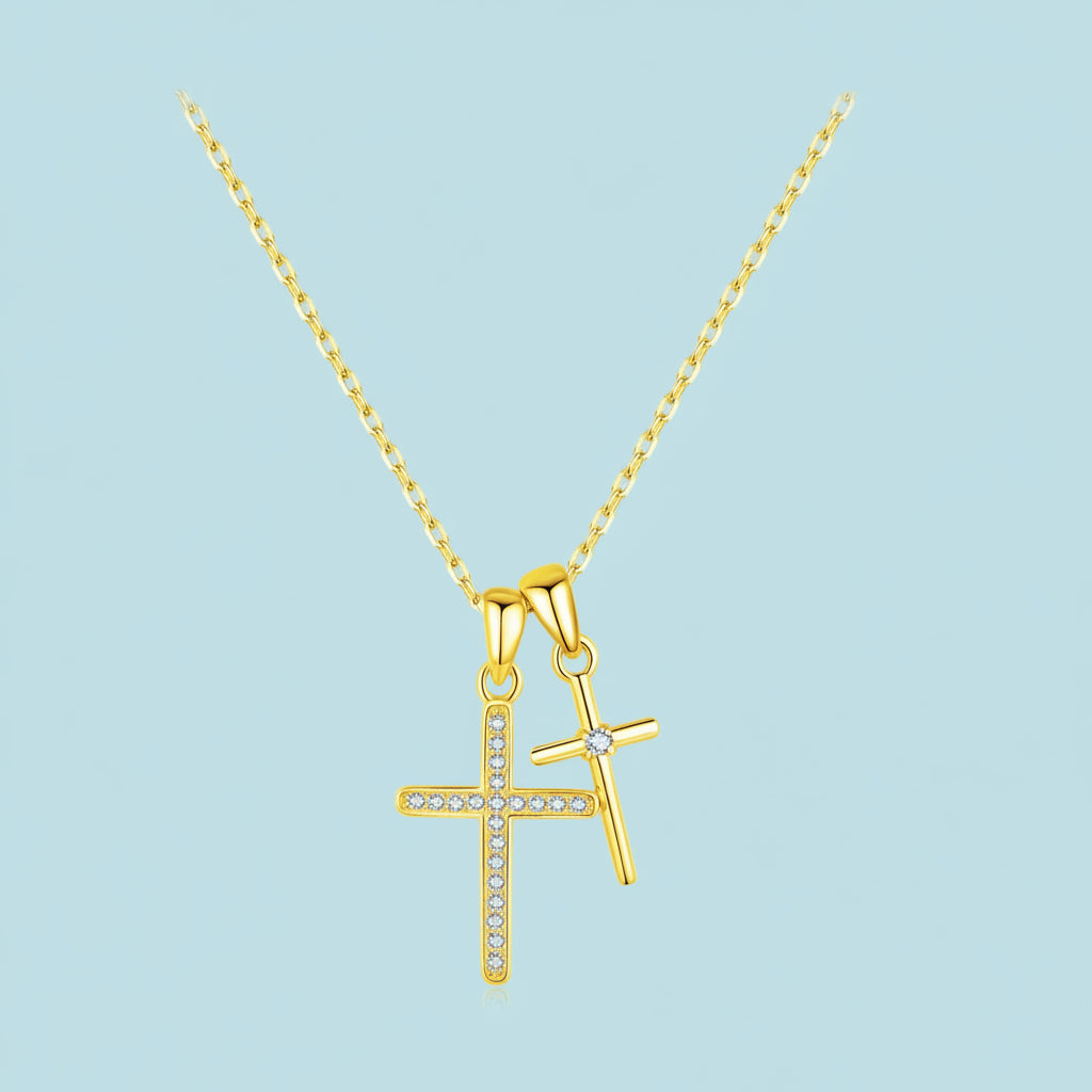 Gold cross pendant necklace on a light blue background
