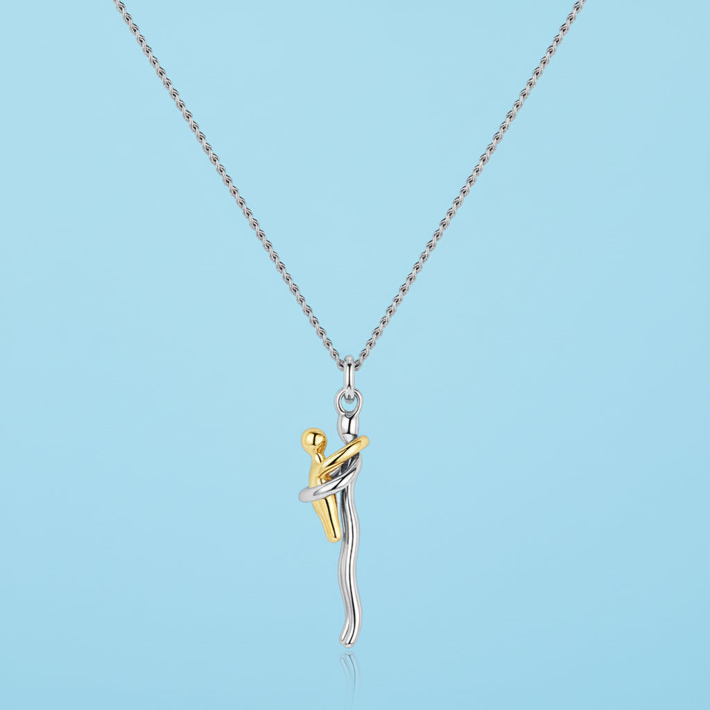 Two-tone pendant necklace on a light blue background