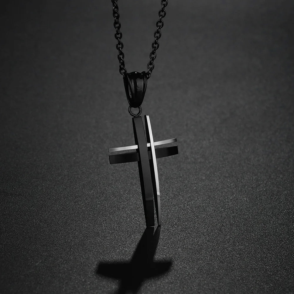 Black cross pendant necklace on a dark gray background