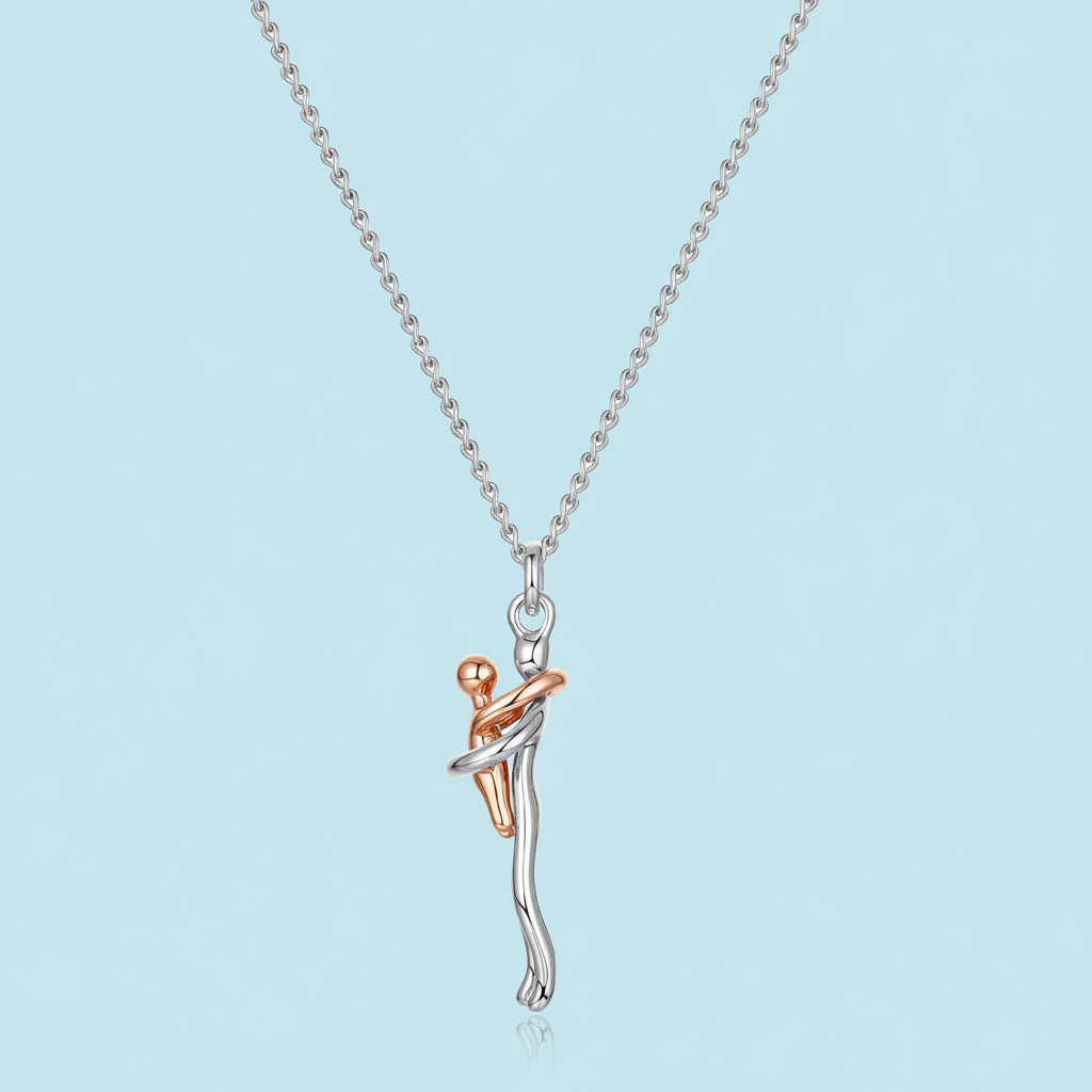 Silver and rose gold necklace with a unique pendant on a light blue background