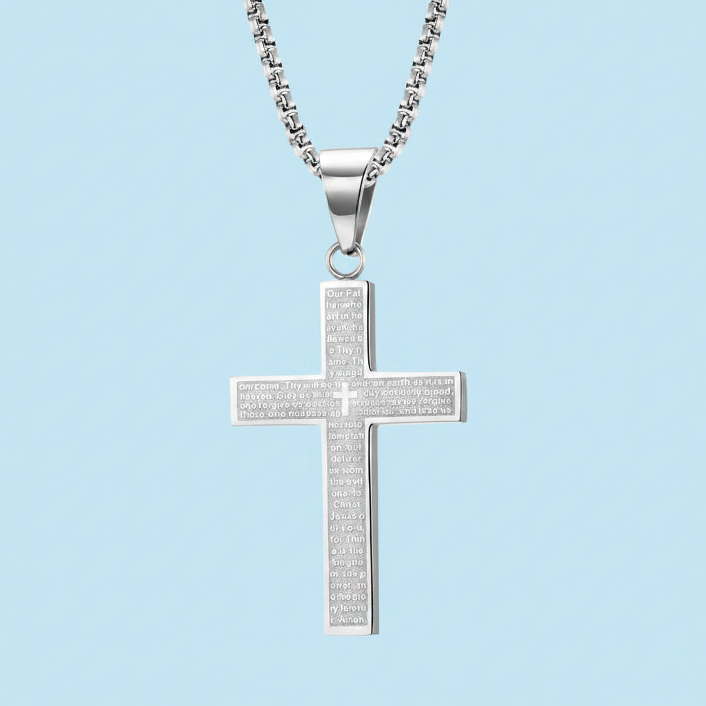 Silver cross pendant necklace on a light blue background
