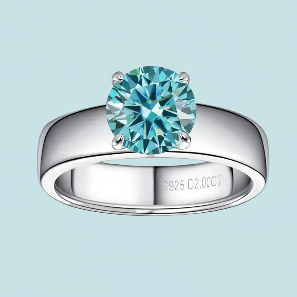 Silver ring with a blue gemstone on a light blue background