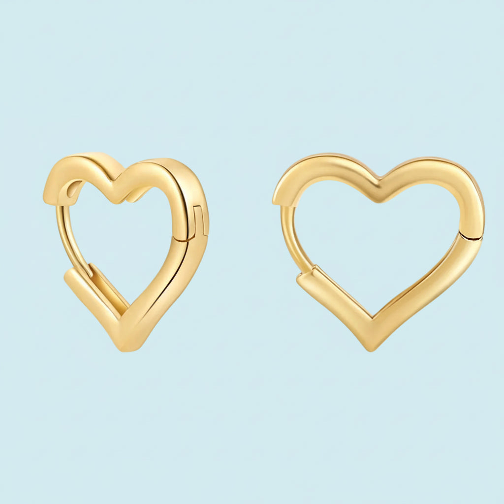 Gold heart-shaped hoop earrings on a white background