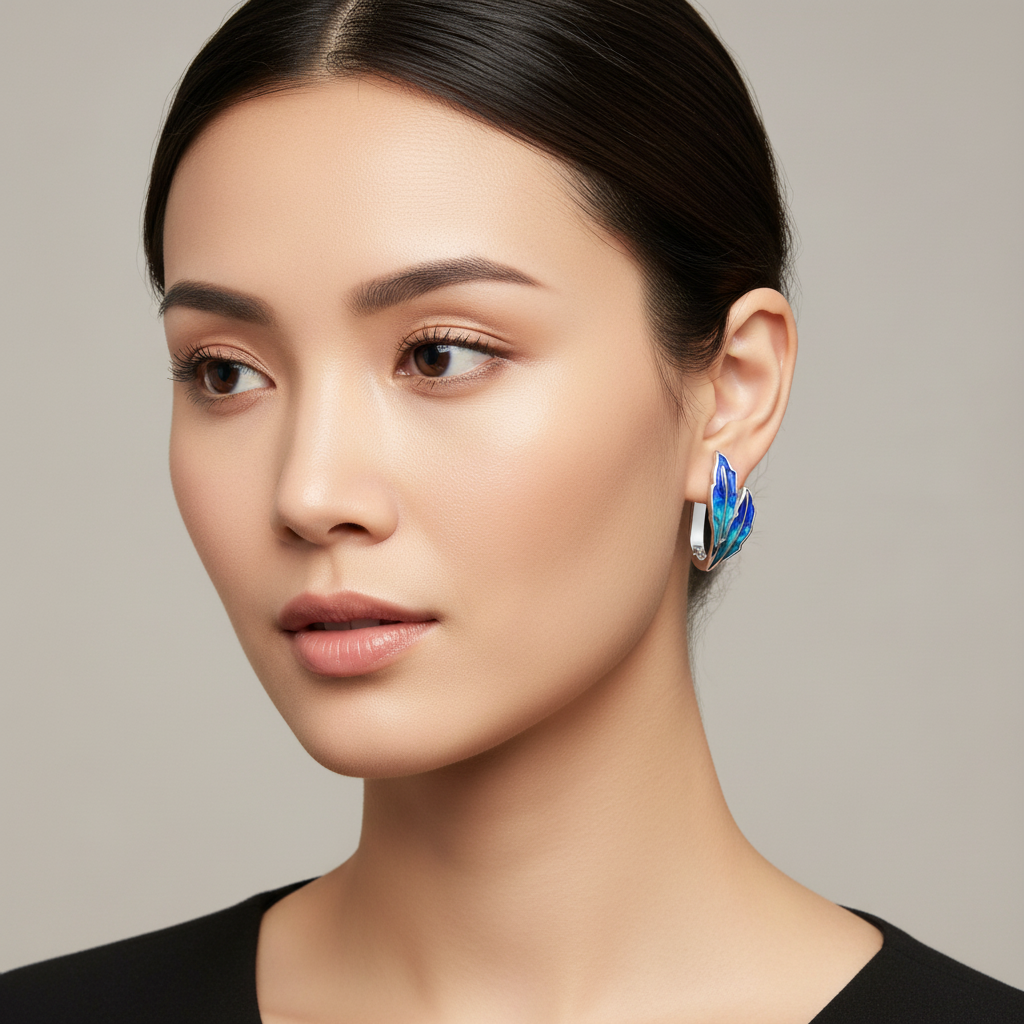 Woman wearing a peacock feather earring against a neutral background