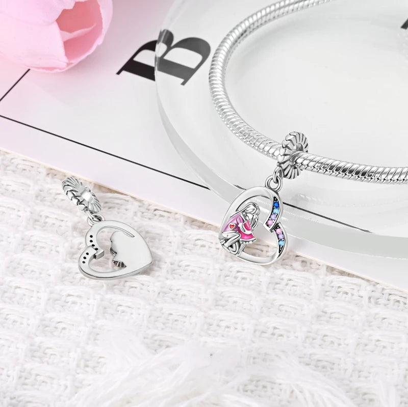 Silver bracelet with heart-shaped charms on a textured surface