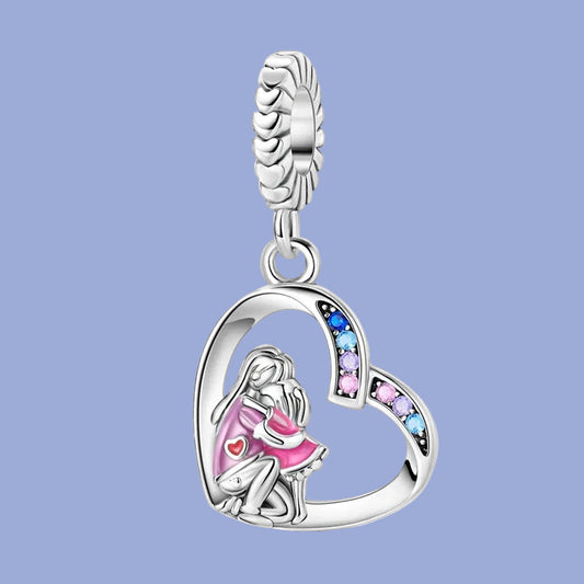 Silver pendant with a heart design featuring a girl and colorful stones on a blue background