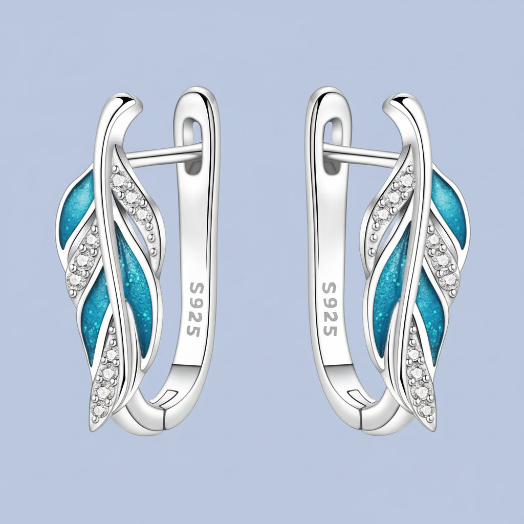 Silver earrings with blue accents and 'S925' stamp on a white background