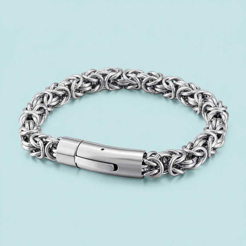 Silver chain bracelet on a light blue background