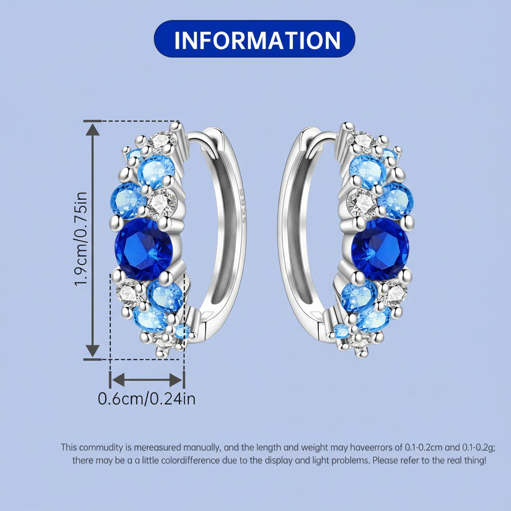 Silver hoop earrings with blue gemstones and measurements on a light blue background