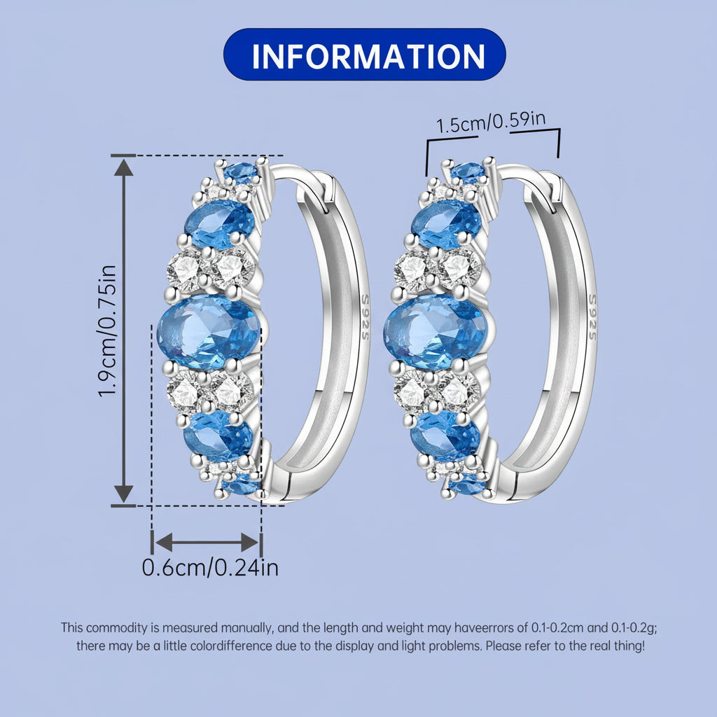 Pair of hoop earrings with blue gemstones and clear stones, showing measurements on a light blue background.