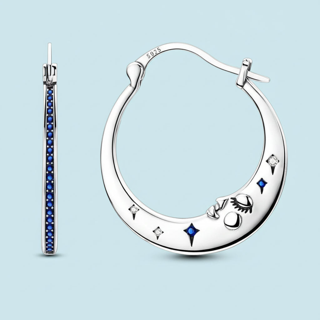 Silver hoop earrings with blue gemstones on a white background