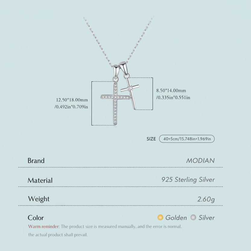 Silver cross pendant necklace with measurement details on a light blue