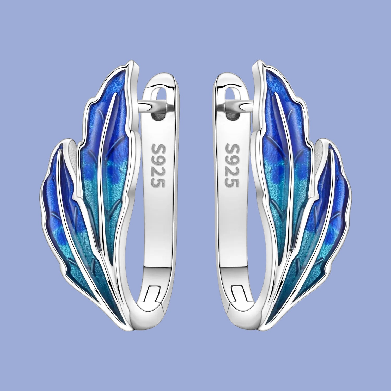 Silver earrings with blue feather design on a white background