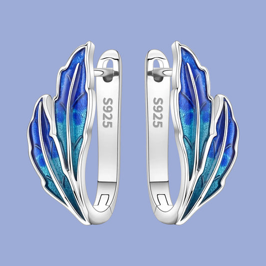 Silver earrings with blue feather design on a white background