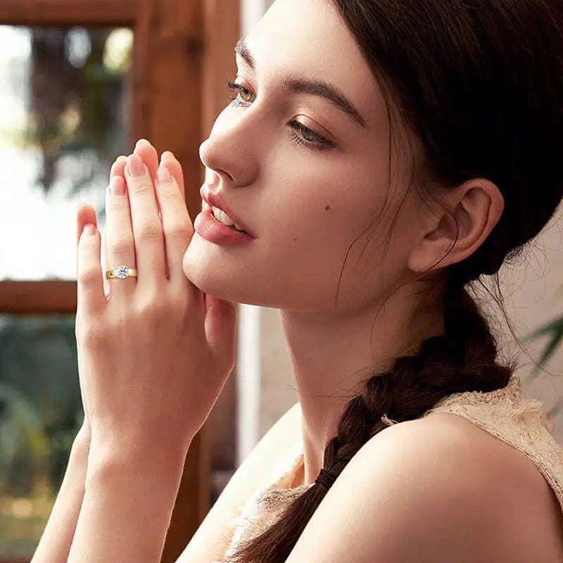 Woman wearing a ring with a blurred outdoor background