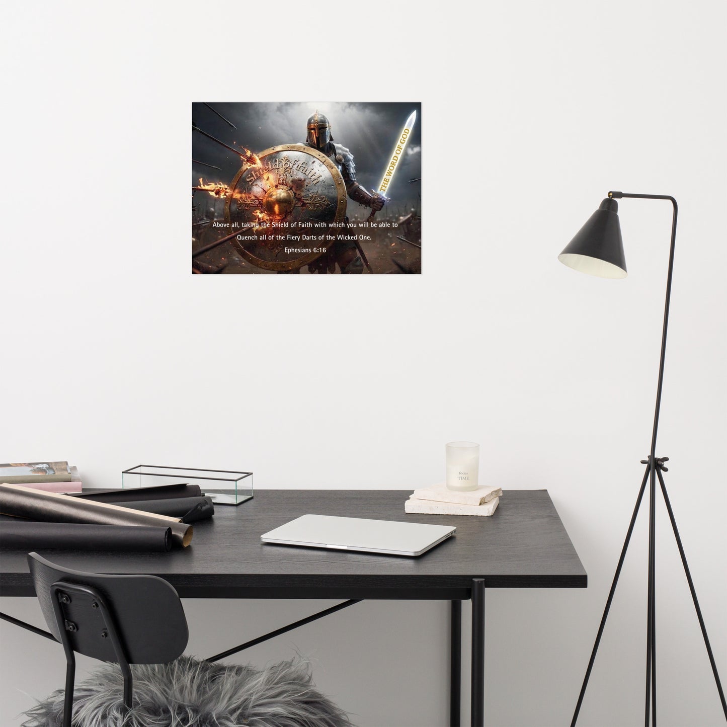 Modern office setup with a desk, chair, and lamp against a white wall with a motivational poster.