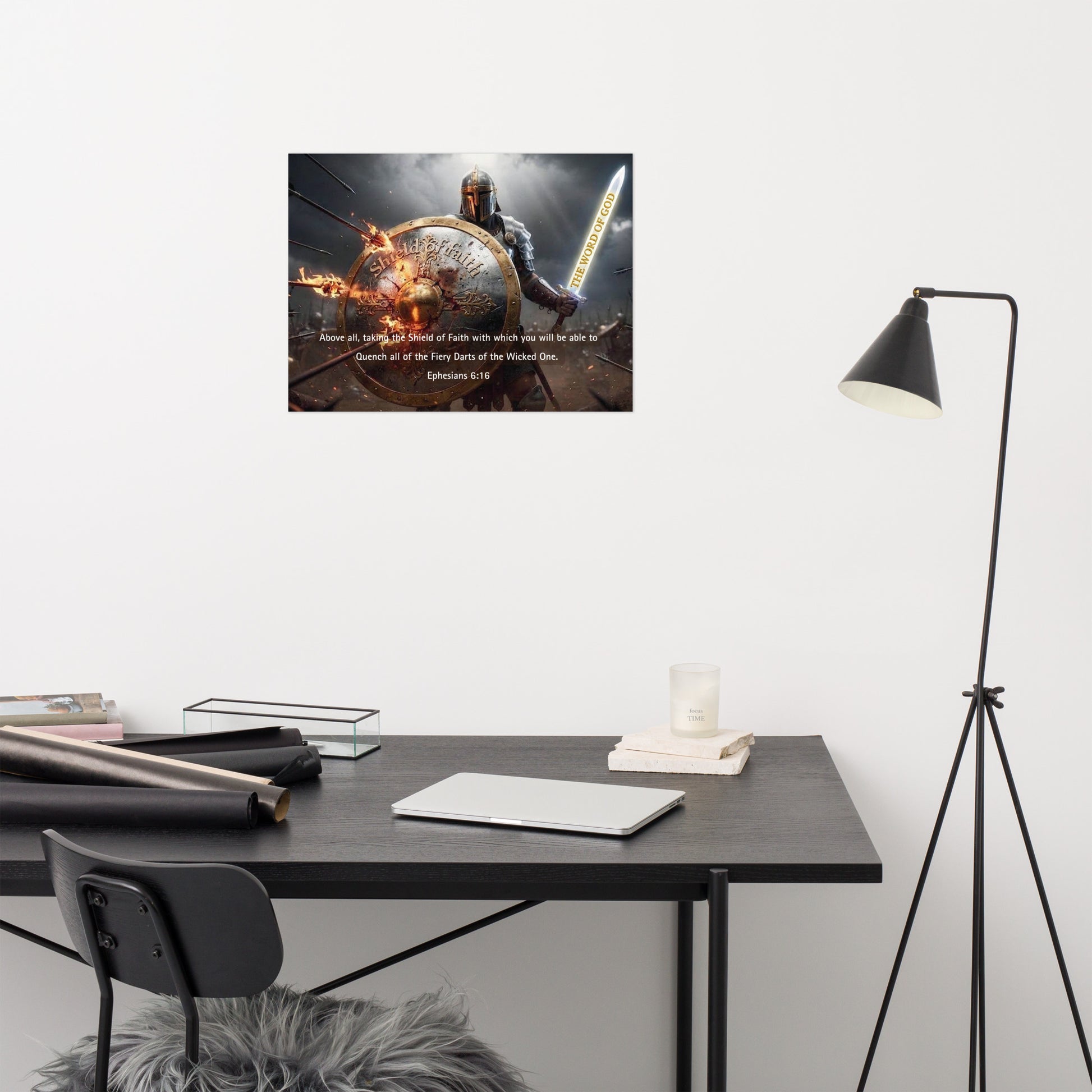 Modern office setup with a desk, chair, and lamp against a white wall with a motivational poster.