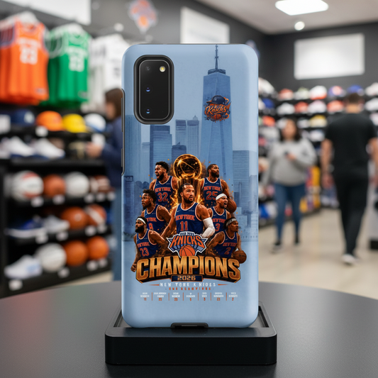 A light blue phone case featuring a New York Knicks championship graphic, displayed on a black stand inside a blurred sports retail store.